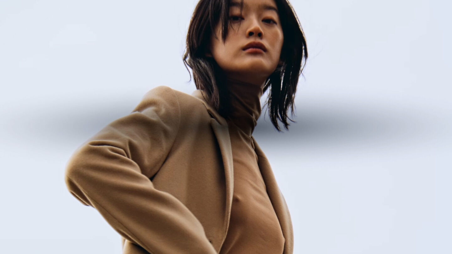 Moving image of a woman wearing Wool Blend Tailored Coat in dark khaki and Jersey Long Sleeve Turtleneck Sweater in color Roasted walnut.
