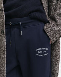 Calças desportivas com grafismo pequeno